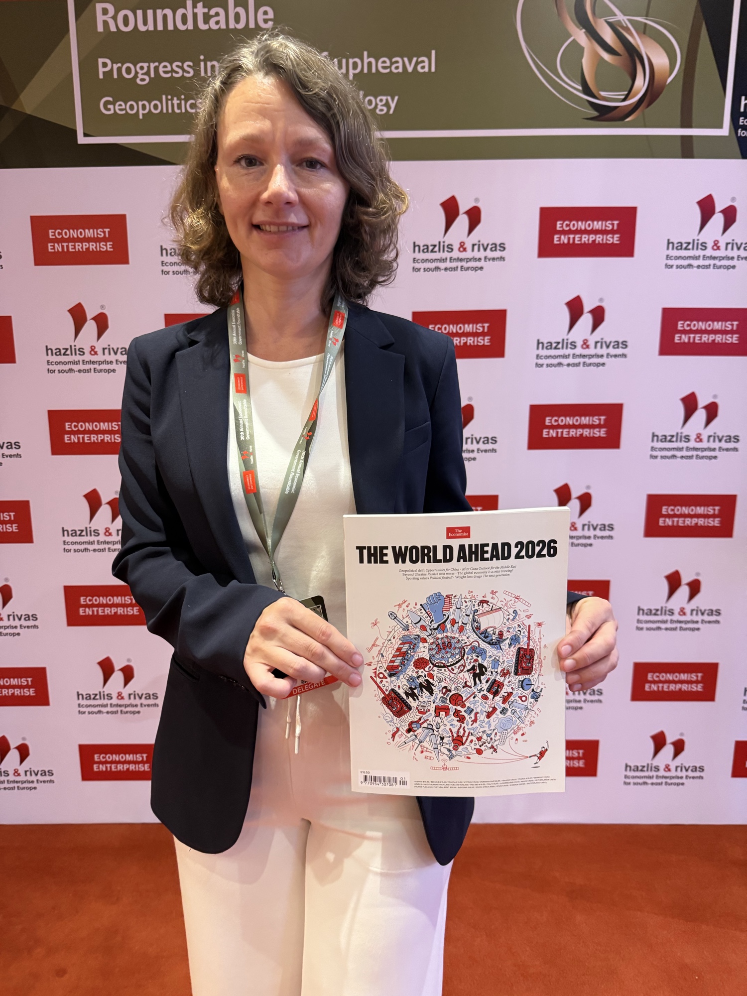 Natalya (Polyushkevych) Meyer, Senior Advisor for Ukraine Partnerships & Defense Technology Transition, on-site at the 30th Annual Government Roundtable, Athens, July 2026, with The Economist&rsquo;s World Ahead 2026 issue.